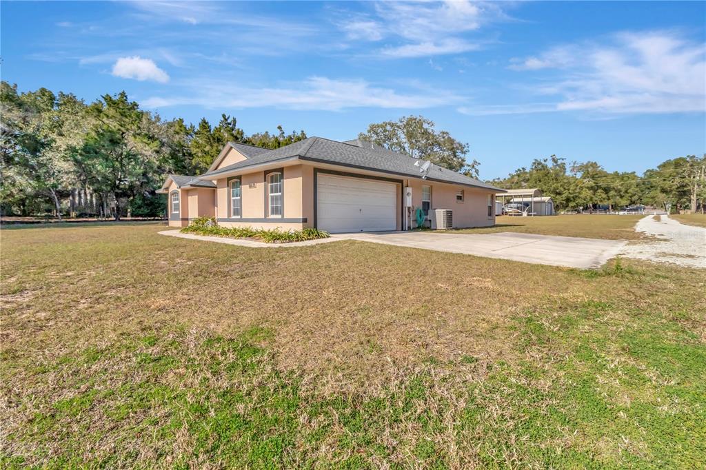 18611 Clark Road Altoona, FL 32702 - Photo 5 of 48 a view of an house with backyard and a garden