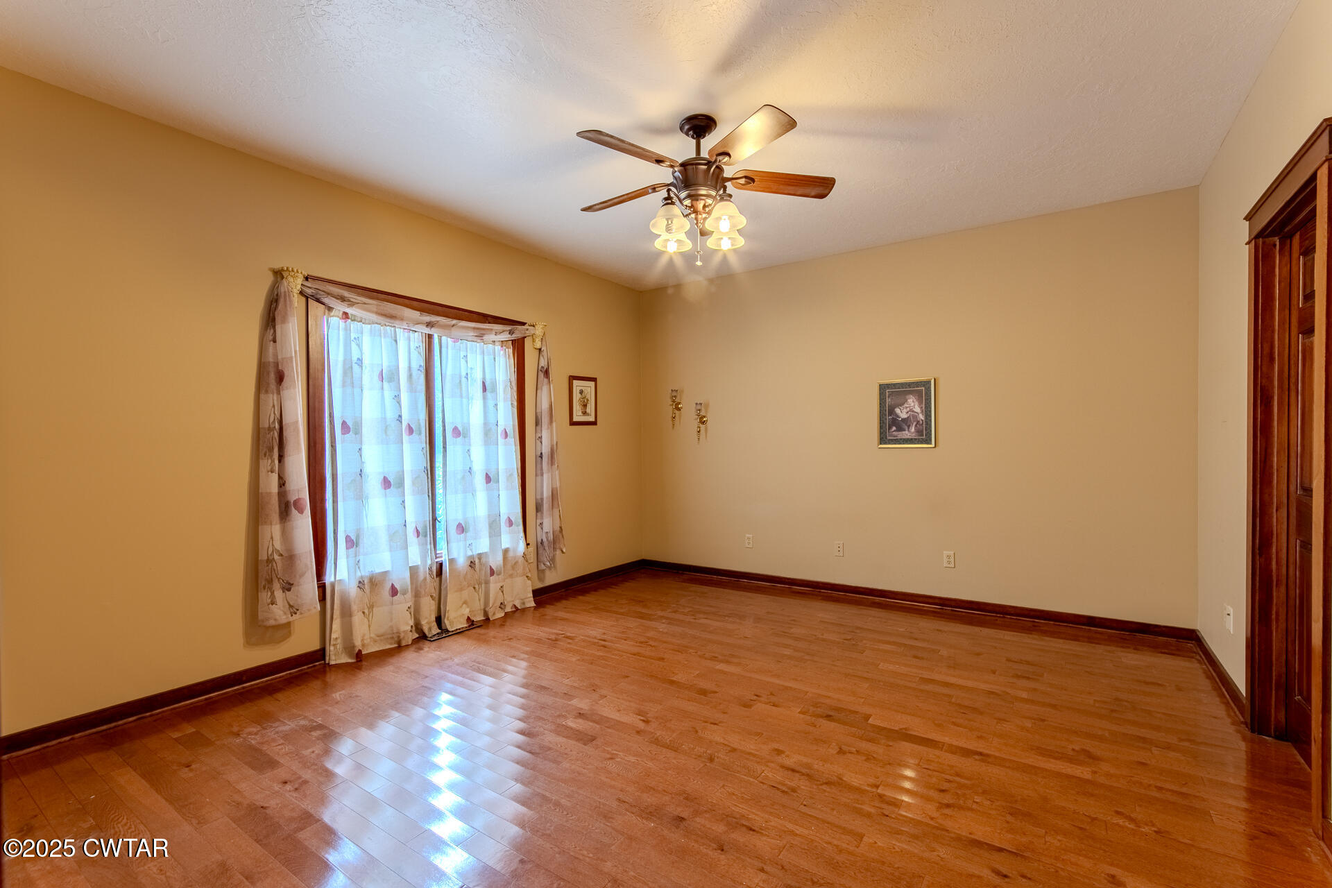 3554 Shades Bridge Road Greenfield, TN 38230 - Photo 21 of 49 an empty room with wooden floor fan and windows
