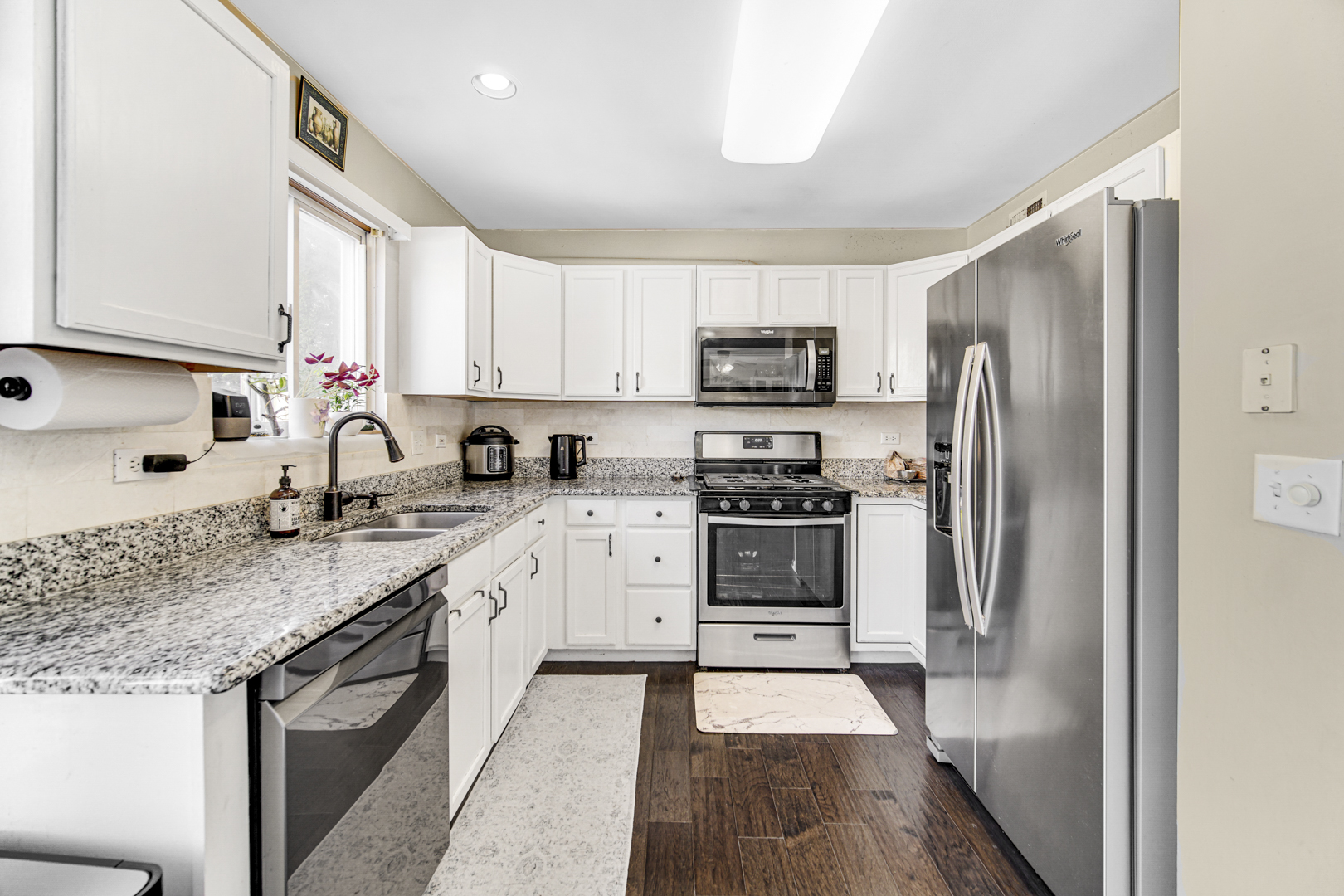 1384 Roxbury Drive Aurora, IL 60502 - Photo 8 of 24 a kitchen with stainless steel appliances granite countertop a refrigerator sink and stove