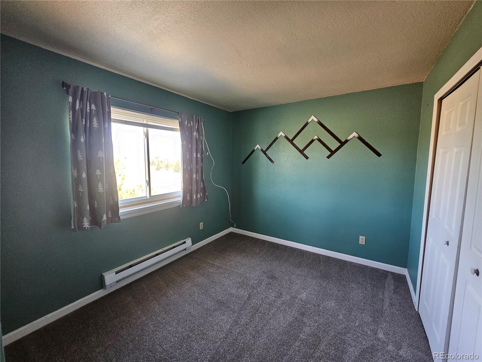 16985 Sage Crest Road Peyton, CO 80831 - Photo 13 of 25 an empty room with a window and a fan