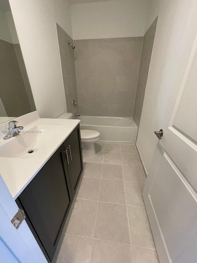2634 Southeast 11th Court, Unit 2634 Homestead, FL 33035 - Photo 13 of 20 a bathroom with a sink a toilet and shower