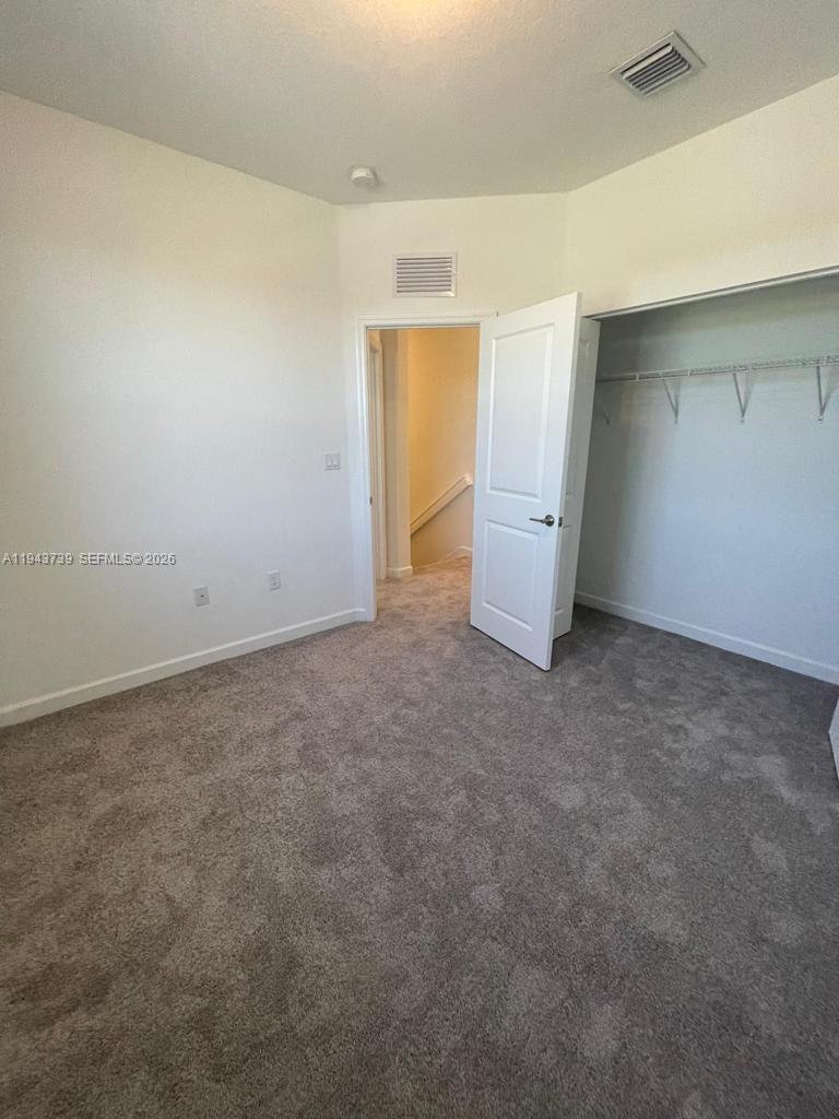 2634 Southeast 11th Court, Unit 2634 Homestead, FL 33035 - Photo 17 of 20 an empty room with closet