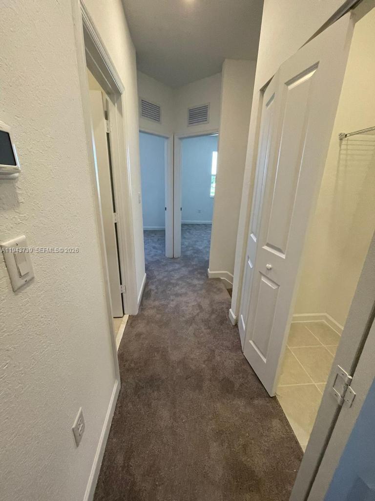 2634 Southeast 11th Court, Unit 2634 Homestead, FL 33035 - Photo 10 of 20 a view of a hallway with a door