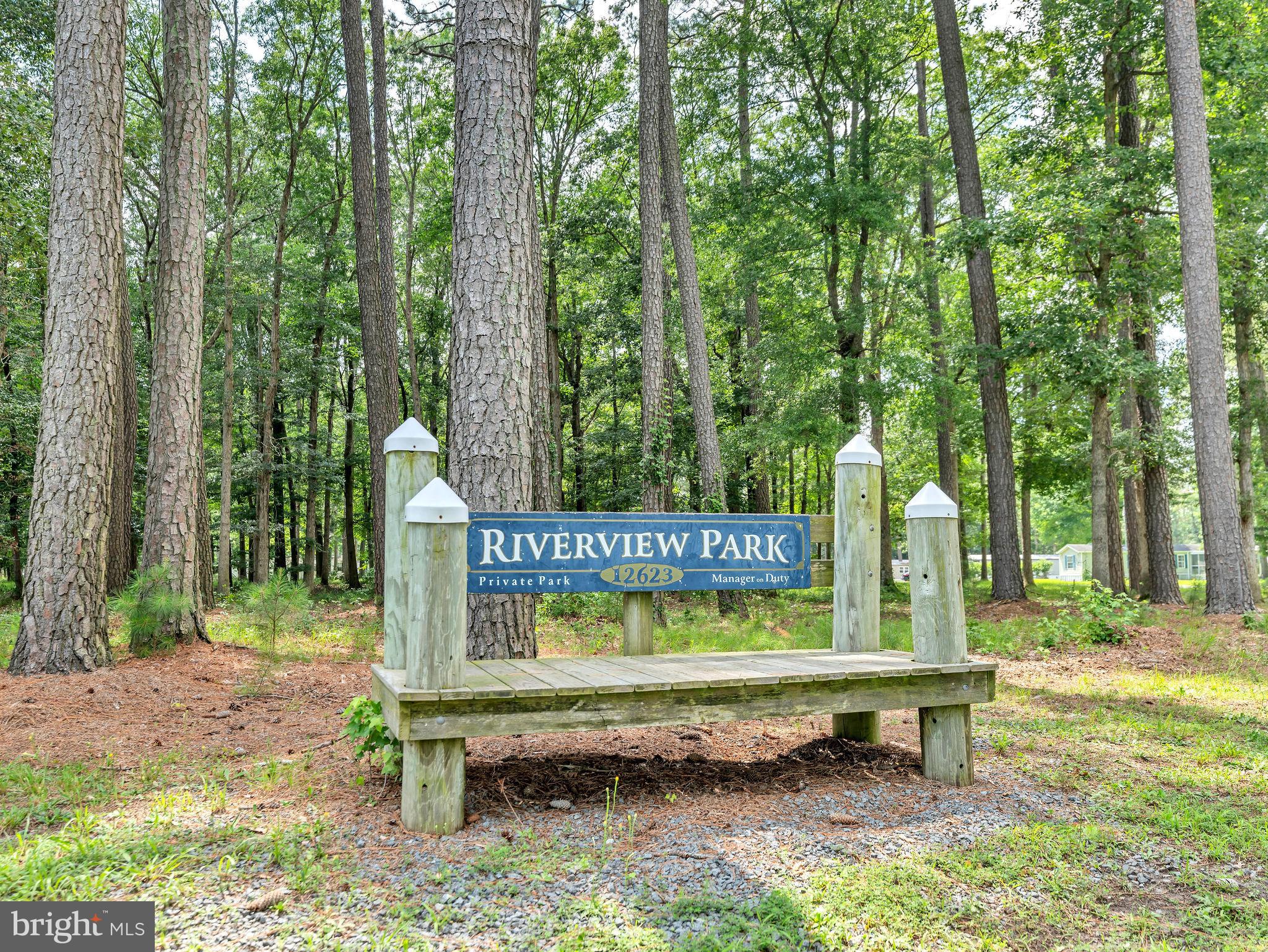 12623 Shell Mill Road, Unit 54 Bishopville, MD 21813 - Photo 19 of 24 a bench sitting in the middle of a park