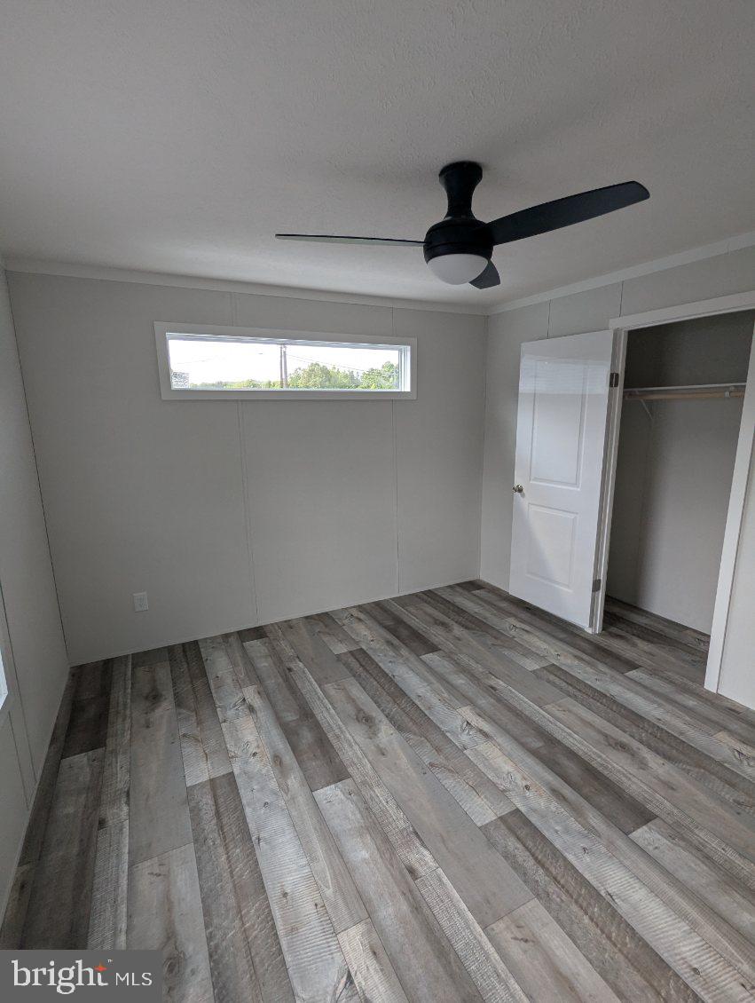 12623 Shell Mill Road, Unit 54 Bishopville, MD 21813 - Photo 7 of 24 a view of empty room with wooden floor