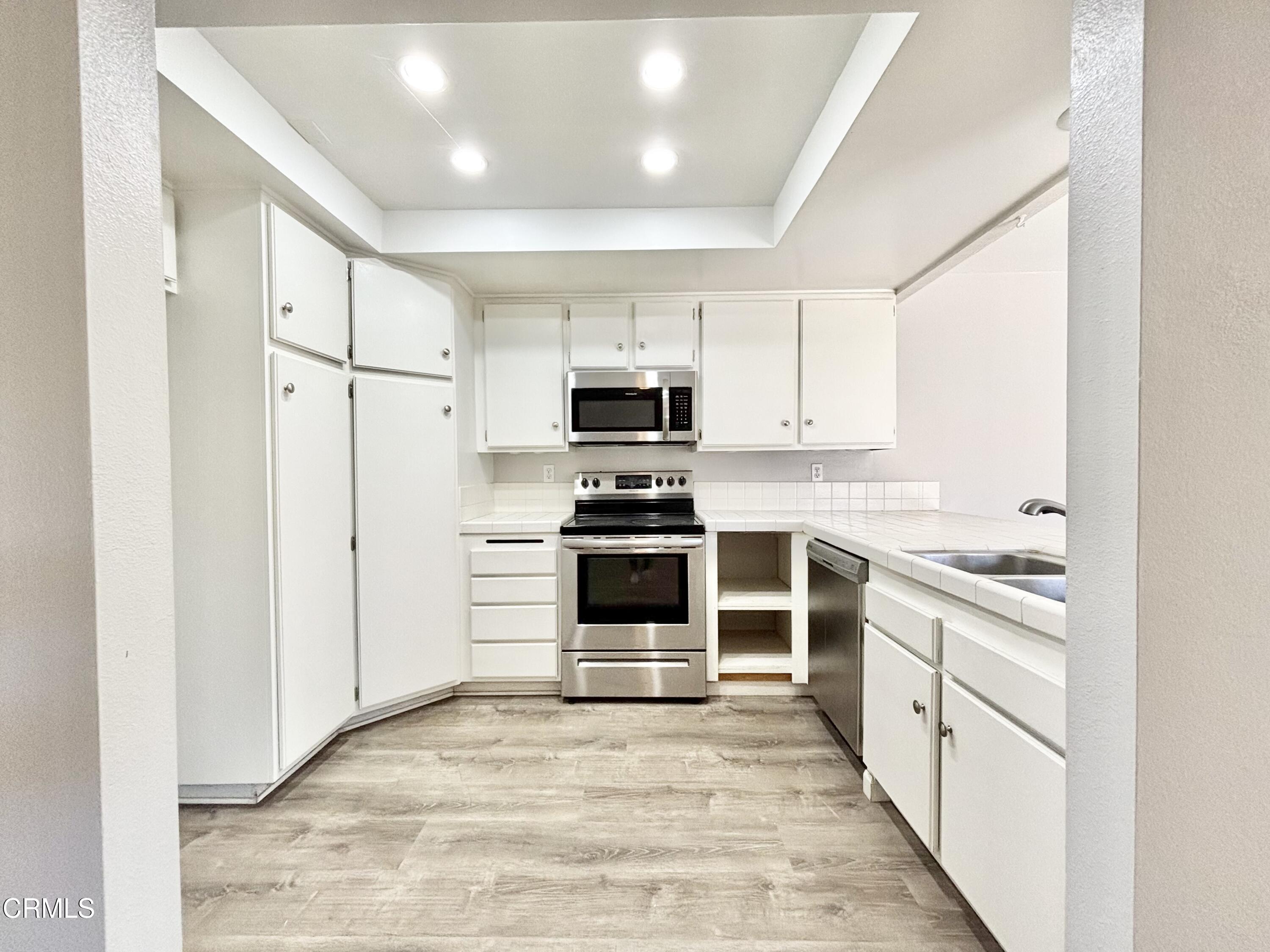 3604 Ketch Avenue Oxnard, CA 93035 - Photo 3 of 38 a kitchen with white cabinets and appliances