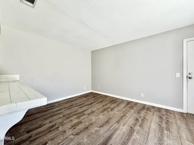 a view of a room with wooden floor
