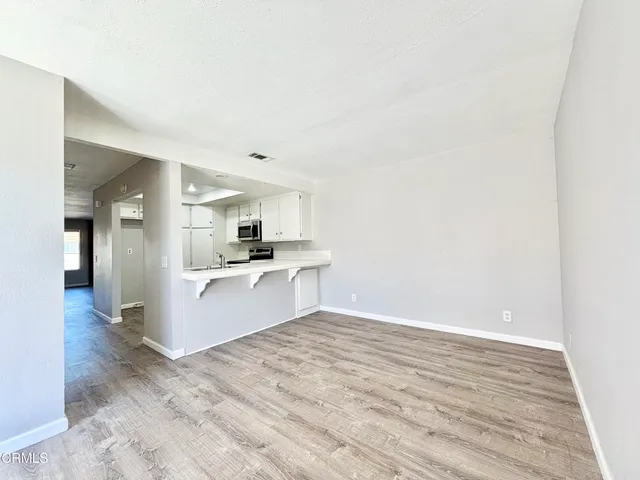 a view of kitchen with wooden floor
