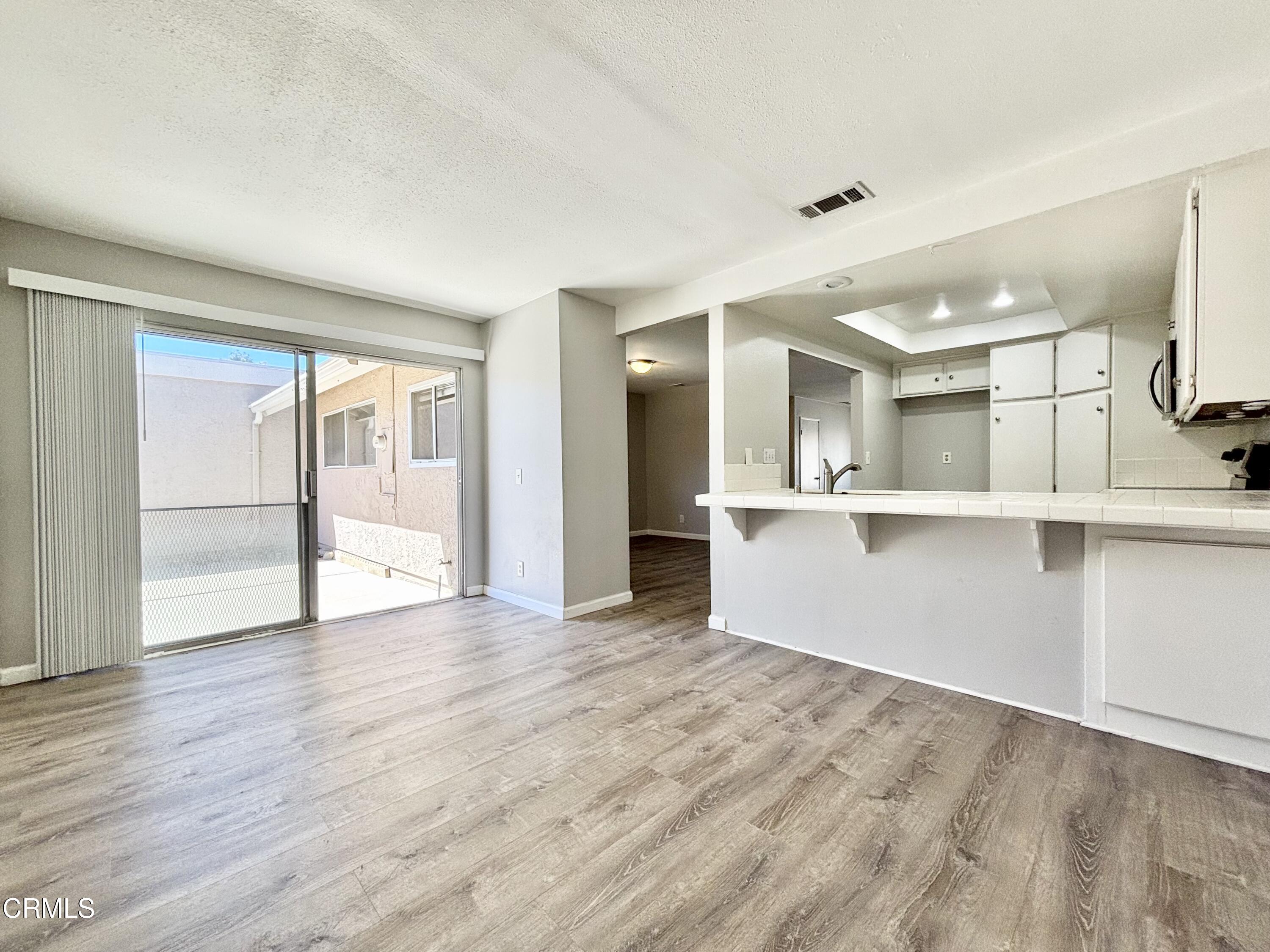 3604 Ketch Avenue Oxnard, CA 93035 - Photo 9 of 38 an empty room with wooden floor and windows