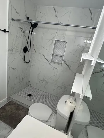 a bathroom with a toilet and shower