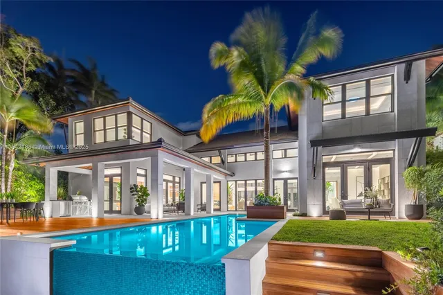 a living room with furniture and large windows