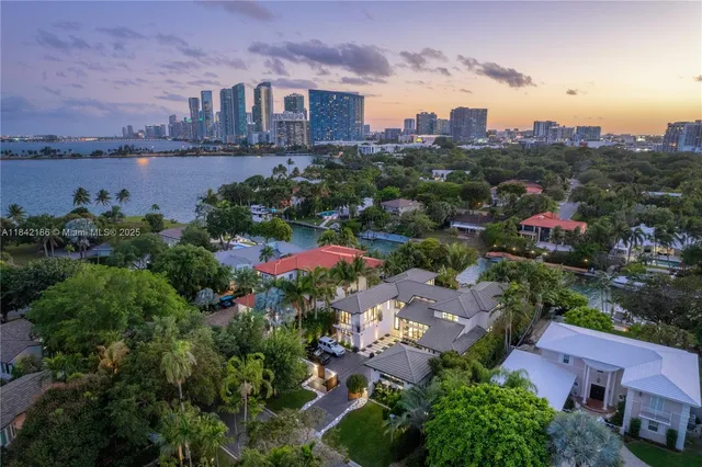 a bedroom with a large bed and a potted plant