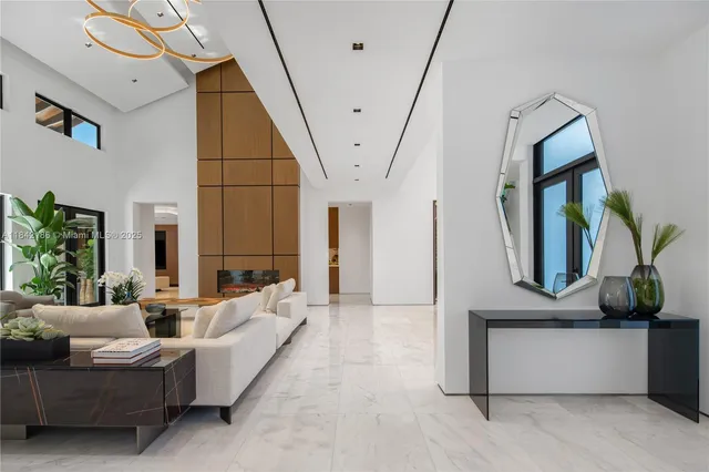 a living room with furniture and a floor to ceiling window