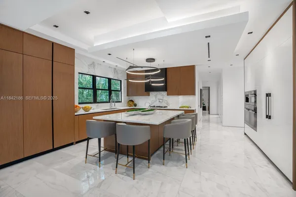a bedroom with a bed and a flat screen tv on dresser