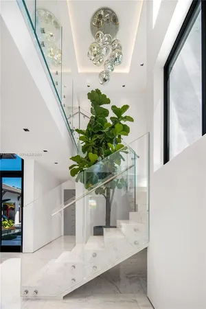 an aerial view of a house with a garden and lake view