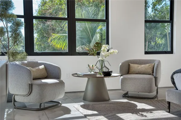 an aerial view of a house with a yard and a large tree