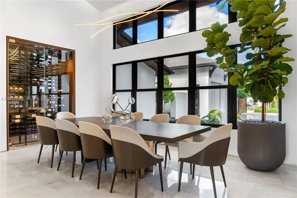 an aerial view of a city with lots of residential buildings ocean and mountain view in back