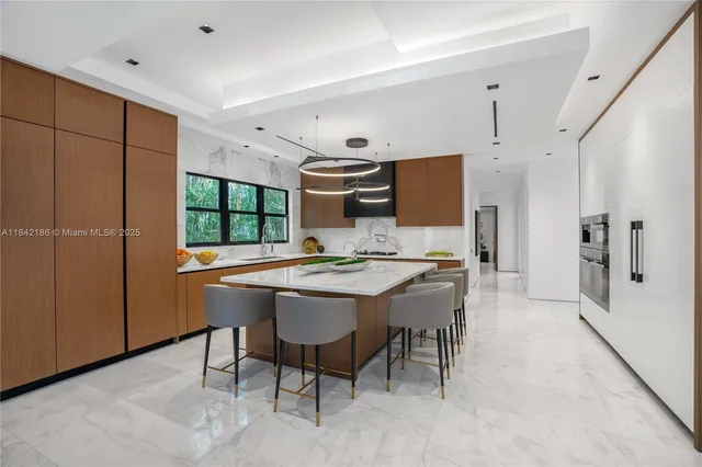 an aerial view of a city with lots of residential buildings ocean and mountain view in back