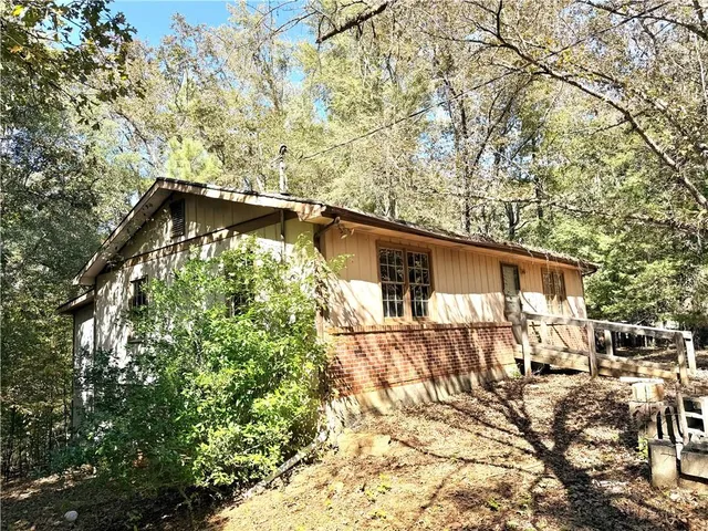 a backyard of a house with table and chairs
