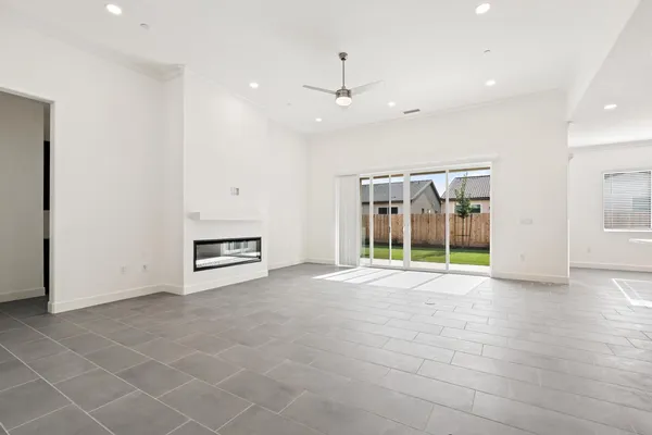 a large kitchen with stainless steel appliances a counter top a refrigerator and a sink