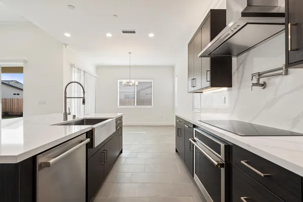 a kitchen with a sink stove and cabinets