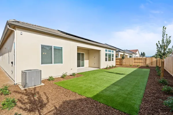 a front view of a house with a garden and yard