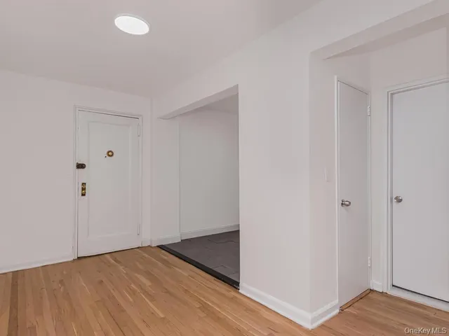 a view of an empty room and wooden floor