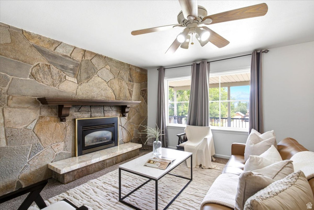 1341 29th Street Ogden, UT 84403 - Photo 5 of 37 Living area featuring a stone accent wall with an integrated fireplace and wood mantel