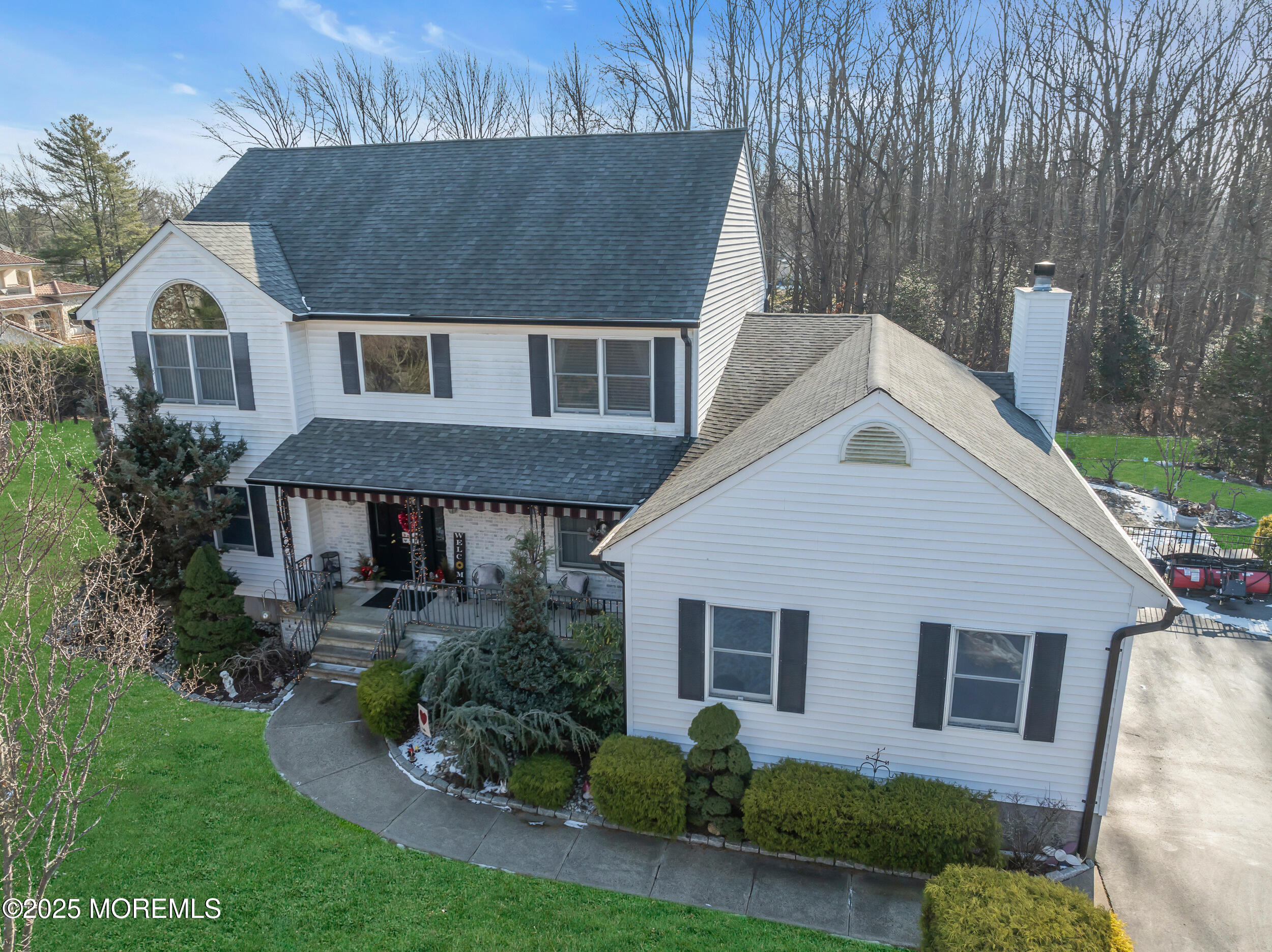 a aerial view of a house next to a yard