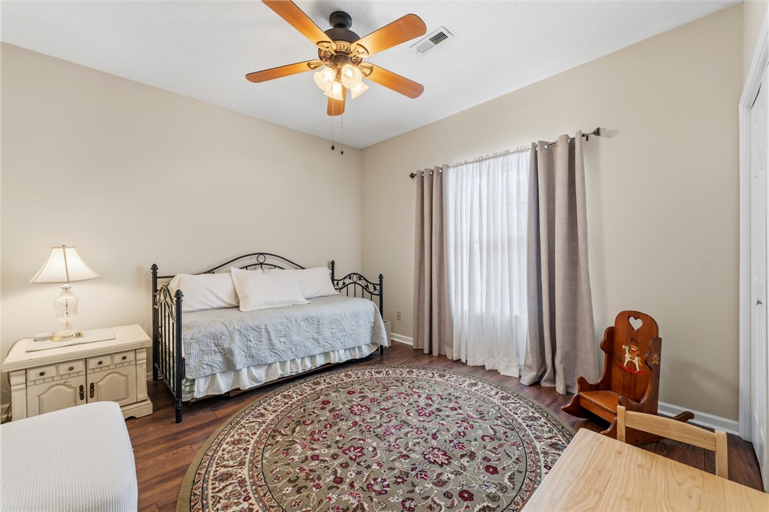 160 Wexford Drive, Unit 206 Anderson, SC 29621 - Photo 28 of 31 Bedroom #3. A well-lit room with LVP flooring and a ceiling fan.