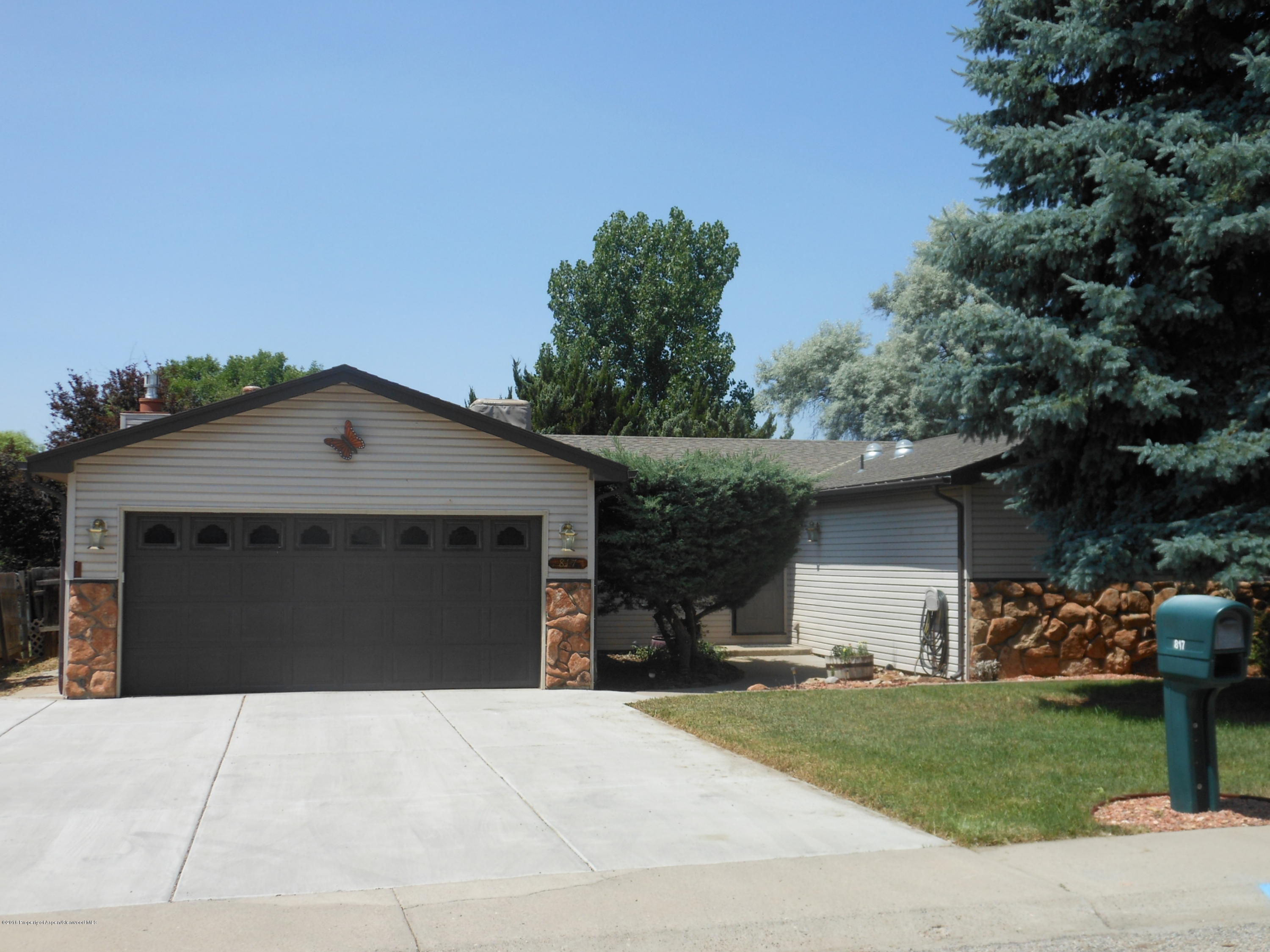 817 Cedar Drive Rifle, CO 81650 - Photo 1 of 24 a front view of a house with a yard and garage