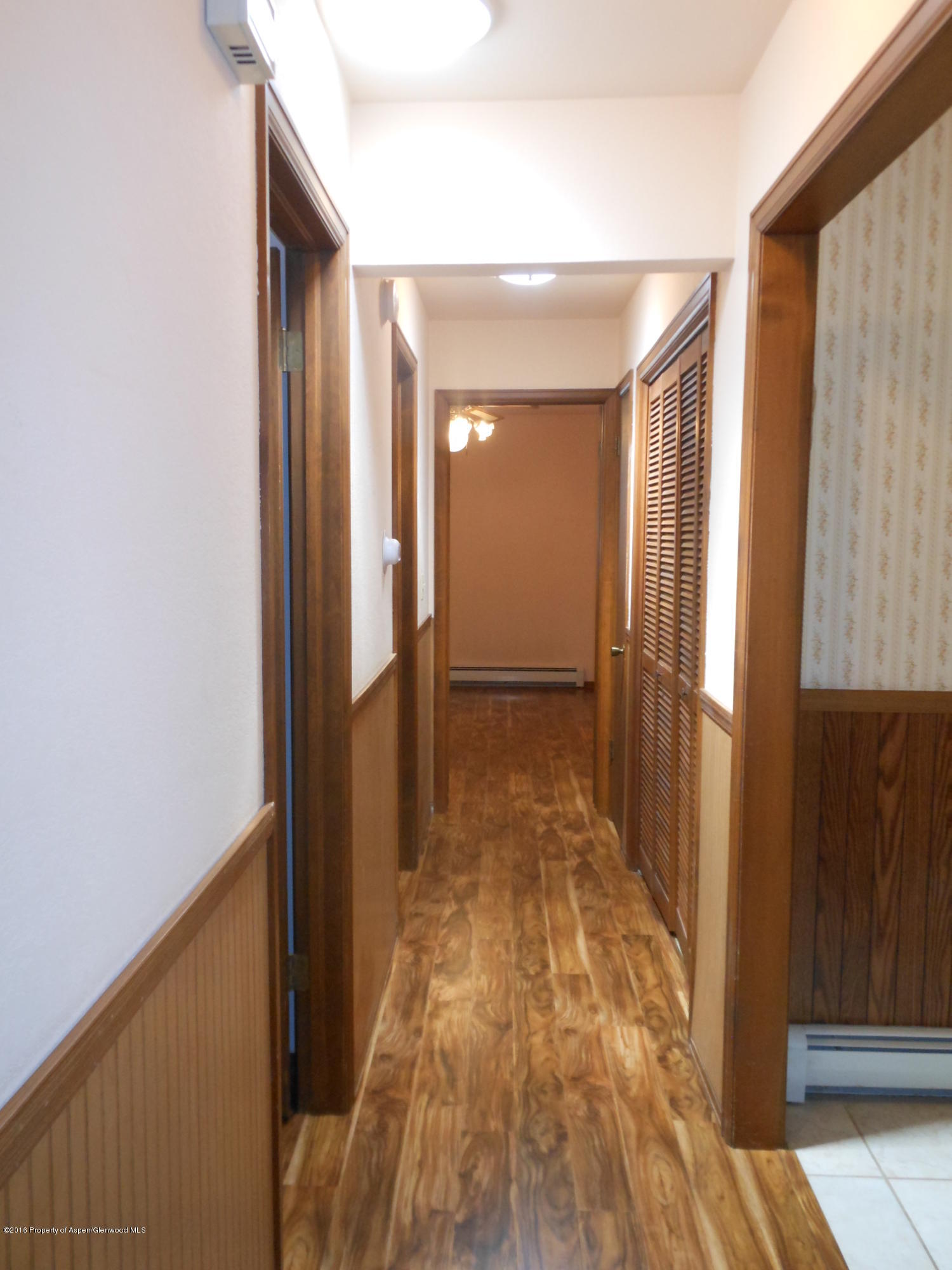 817 Cedar Drive Rifle, CO 81650 - Photo 11 of 24 a view of a hallway with wooden floor and staircase