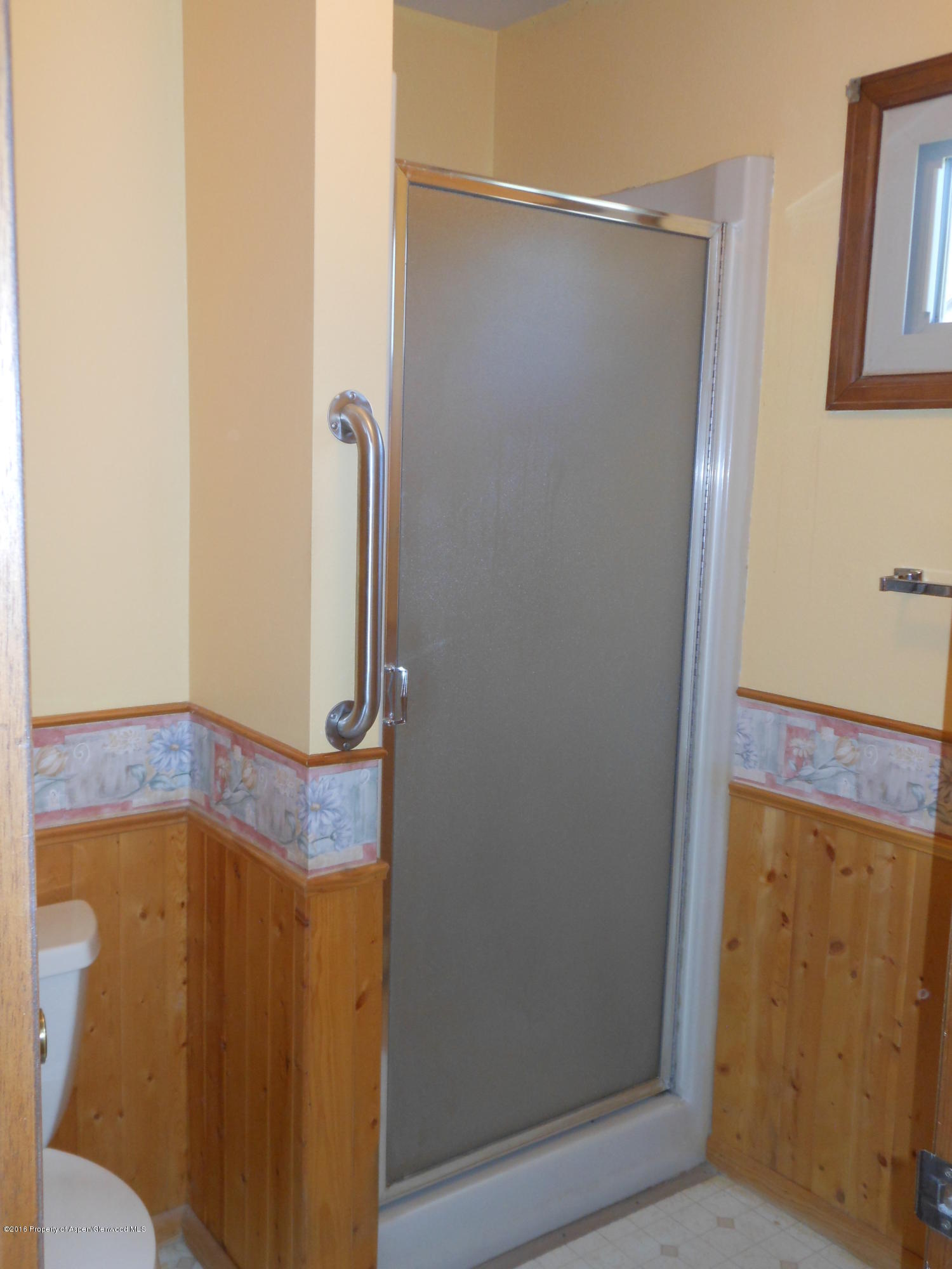 817 Cedar Drive Rifle, CO 81650 - Photo 17 of 24 a bathroom with a shower and a mirror