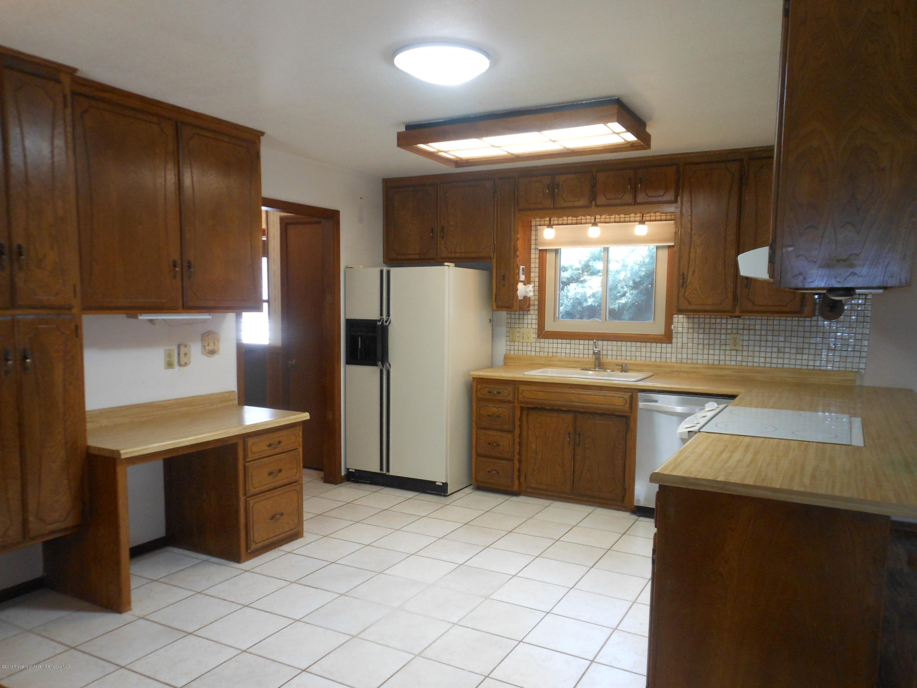 817 Cedar Drive Rifle, CO 81650 - Photo 2 of 24 a kitchen with stainless steel appliances a refrigerator and a stove