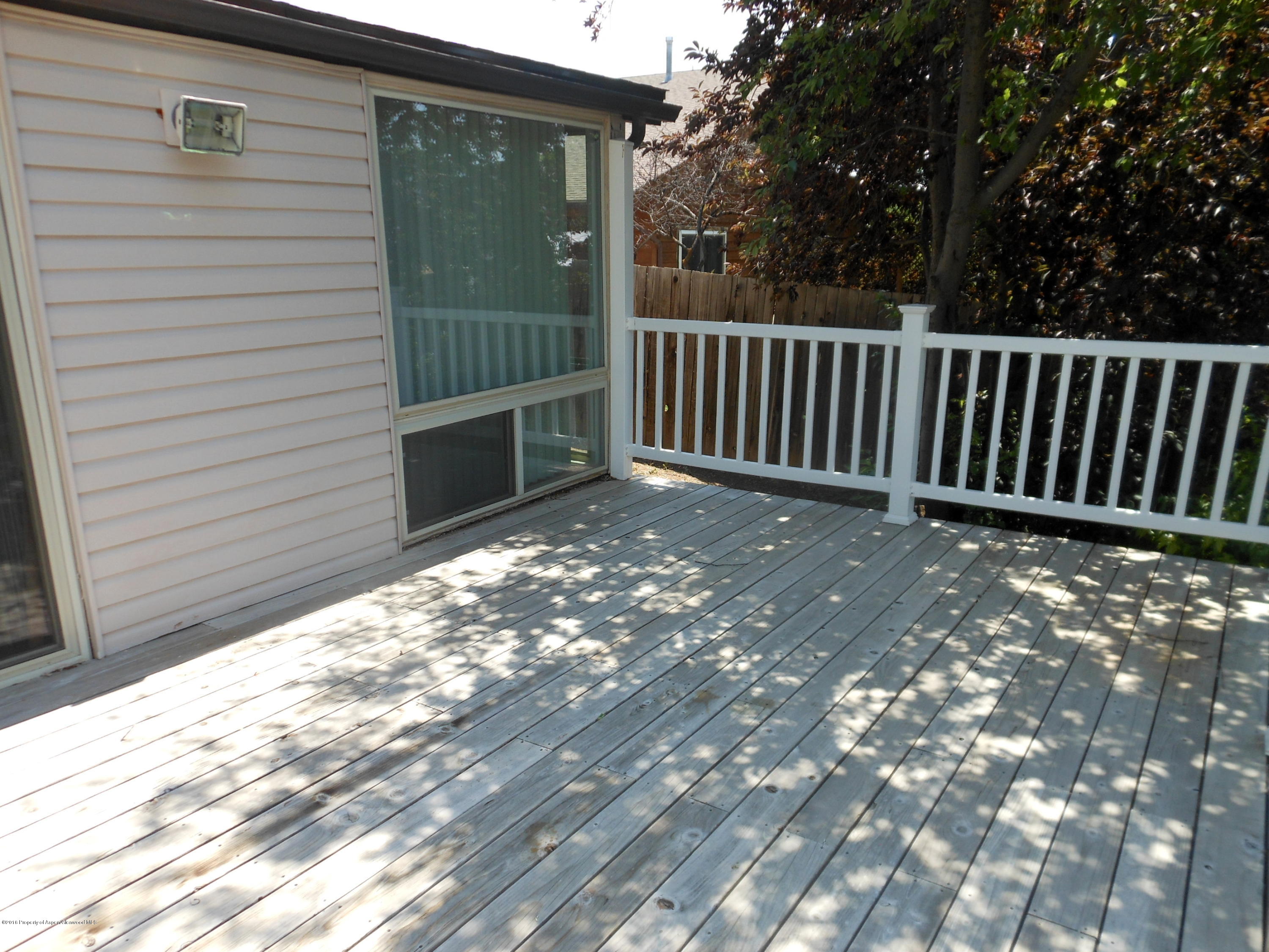 817 Cedar Drive Rifle, CO 81650 - Photo 21 of 24 a view of deck with wooden floor and fence