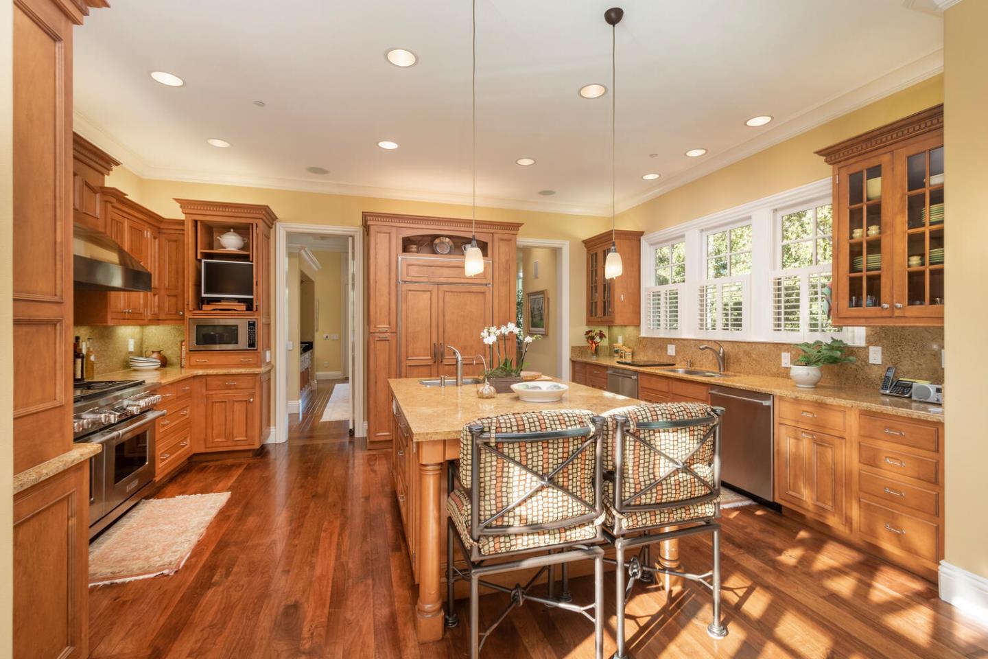 209 Bridge Road Hillsborough, CA 94010 - Photo 14 of 38 a view of a dining room with furniture a kitchen and chandelier