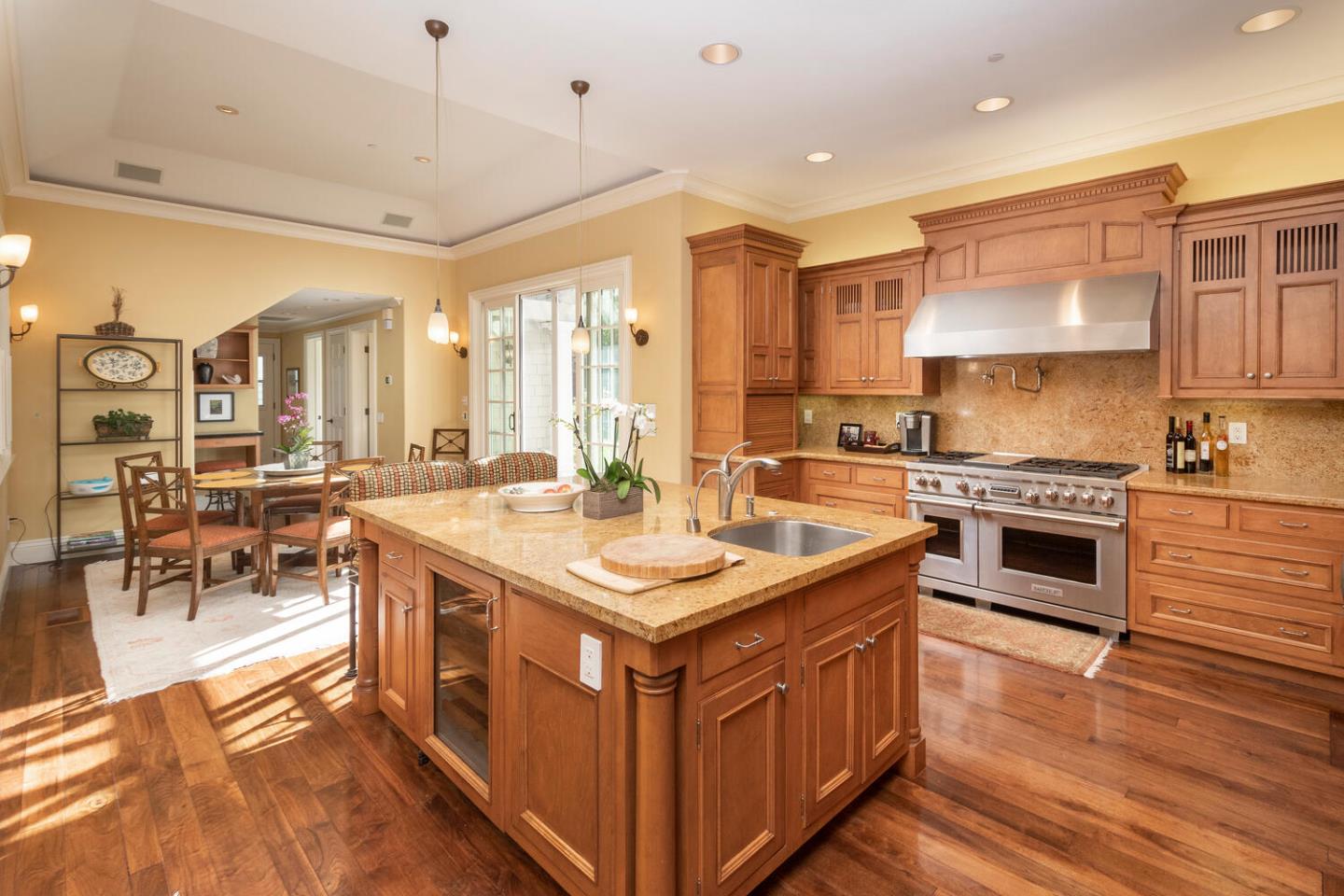 209 Bridge Road Hillsborough, CA 94010 - Photo 15 of 38 a kitchen with stainless steel appliances granite countertop a stove and a view of living room