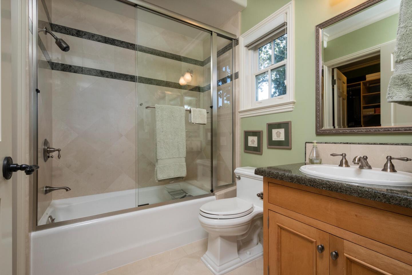 209 Bridge Road Hillsborough, CA 94010 - Photo 27 of 38 a bathroom with a granite countertop sink a toilet and shower