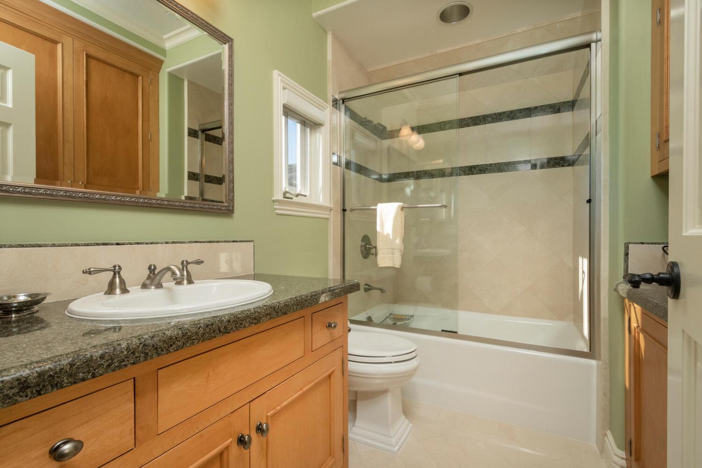 209 Bridge Road Hillsborough, CA 94010 - Photo 30 of 38 a bathroom with a granite countertop sink mirror vanity and toilet