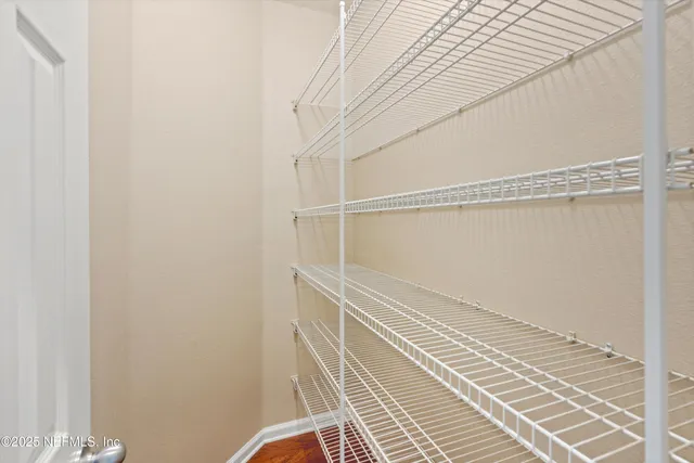 a view of a room with wooden floor