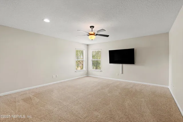 a living room with a flat screen tv and a window