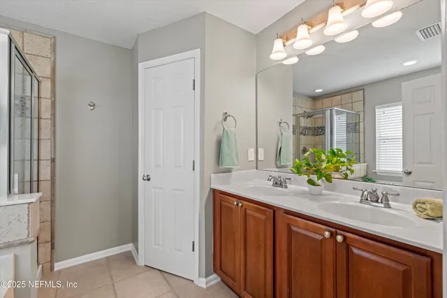 a bathroom with a sink double vanity and a mirror