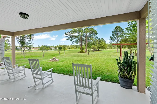 a view of a garden with furniture
