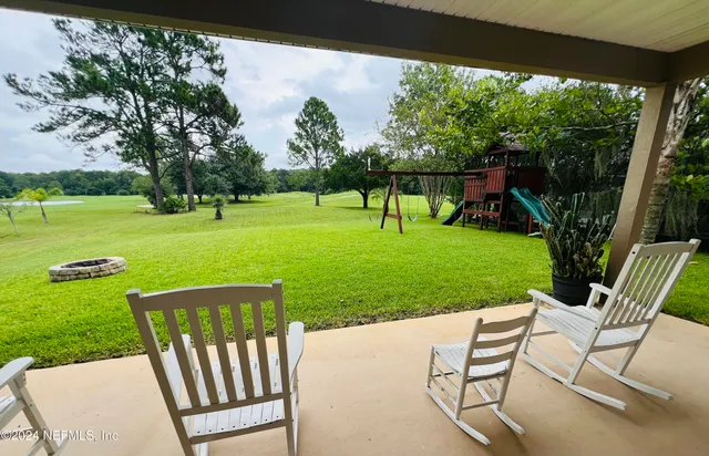 a view of a two chairs and table in a yard
