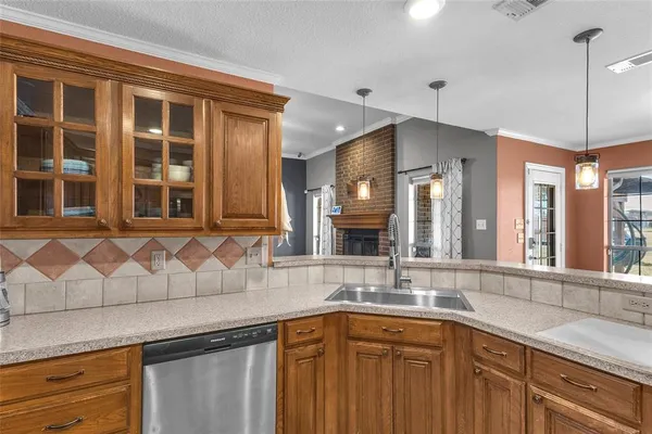 a kitchen with stainless steel appliances granite countertop a sink a window and cabinets