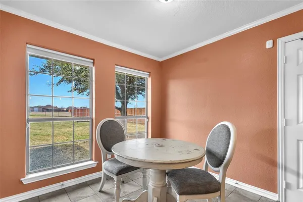 a dining room with furniture and window