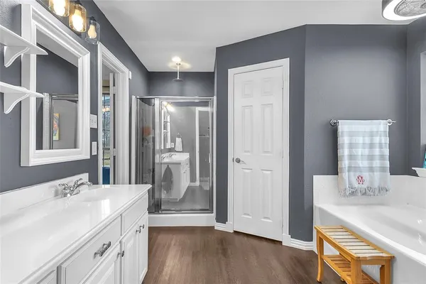 a bathroom with a double vanity sink mirror and shower