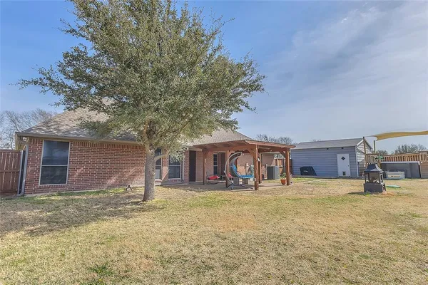 a view of a house with yard and sitting area