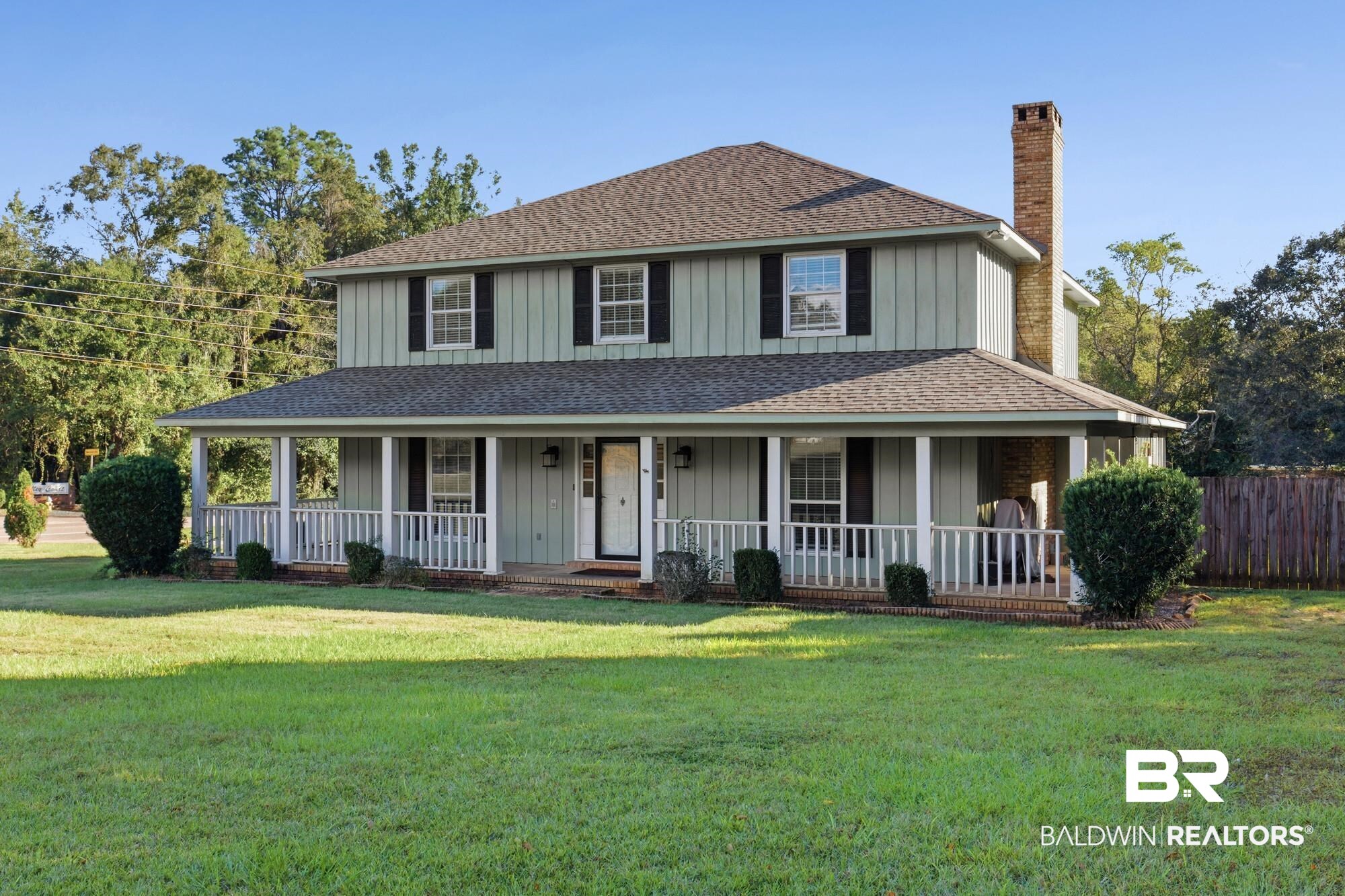 9215 Shiloh Drive Mobile, AL 36695 - Photo 2 of 32 View of front of property with a shingled roof, a large porch, a chimney, and board and batten siding