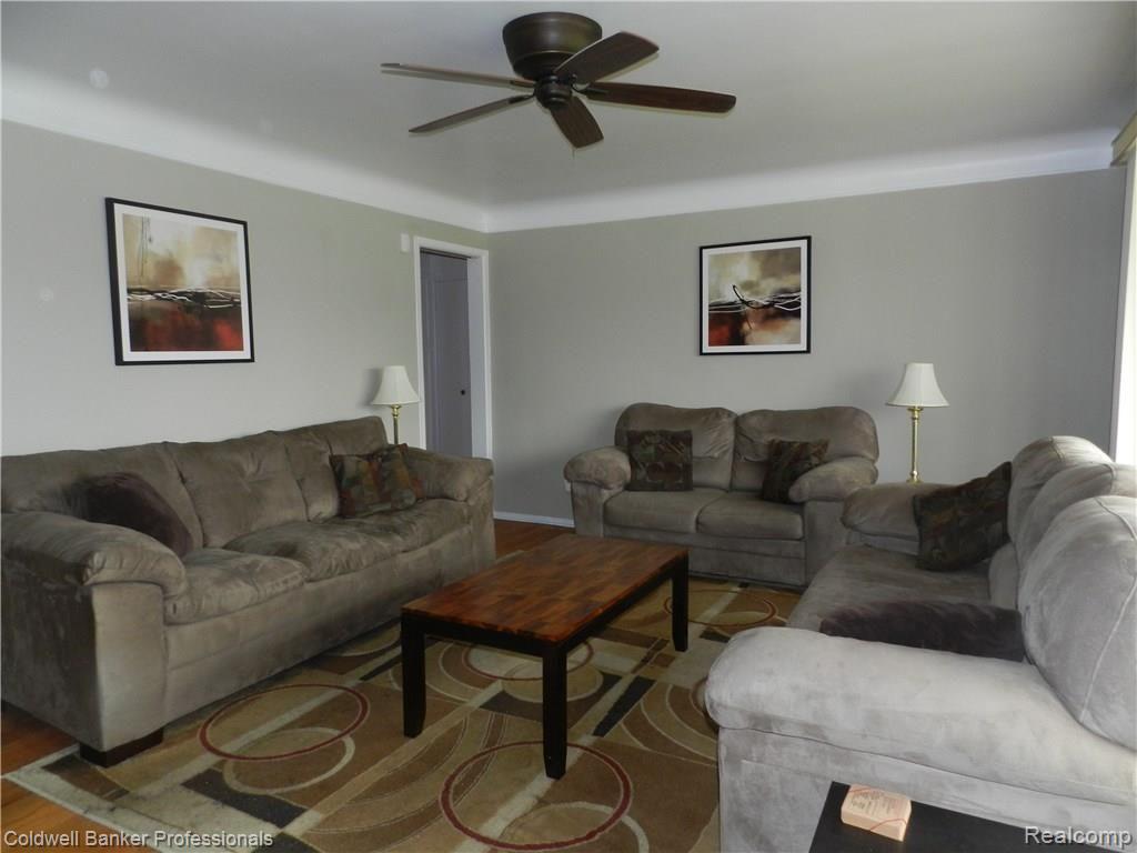 17940 Winsome Road Fraser, MI 48026 - Photo 4 of 24 Spacious living room with coved ceilings, hardwood floors and ceiling fan.